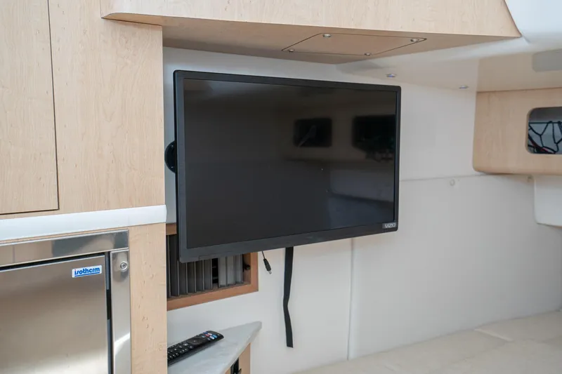 Vaquero Chingon Yacht Photos Pics Interior of 2016 Boston Whaler 370 Outrage with mounted Vizio TV and Isotherm fridge.