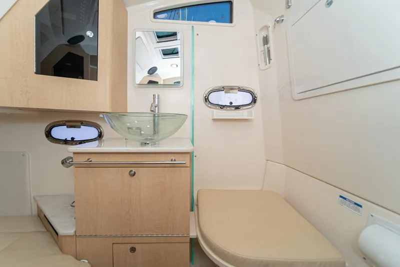 Vaquero Chingon Yacht Photos Pics 2016 Boston Whaler 370 Outrage cabin interior with modern sink and seating area.