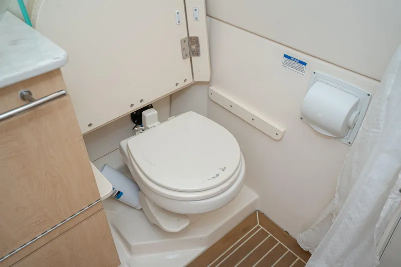 Vaquero Chingon Yacht Photos Pics 2016 Boston Whaler 370 Outrage boat bathroom interior with toilet and cabinetry.