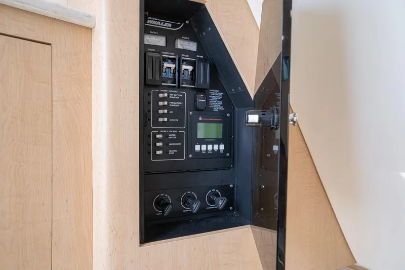 Vaquero Chingon Yacht Photos Pics Electrical panel inside a 2016 Boston Whaler 370 Outrage boat, featuring various controls and switches.