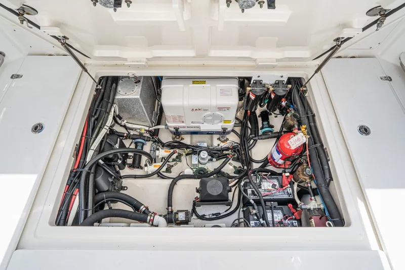 Vaquero Chingon Yacht Photos Pics Engine compartment of 2016 Boston Whaler 370 Outrage, showcasing wiring and equipment.