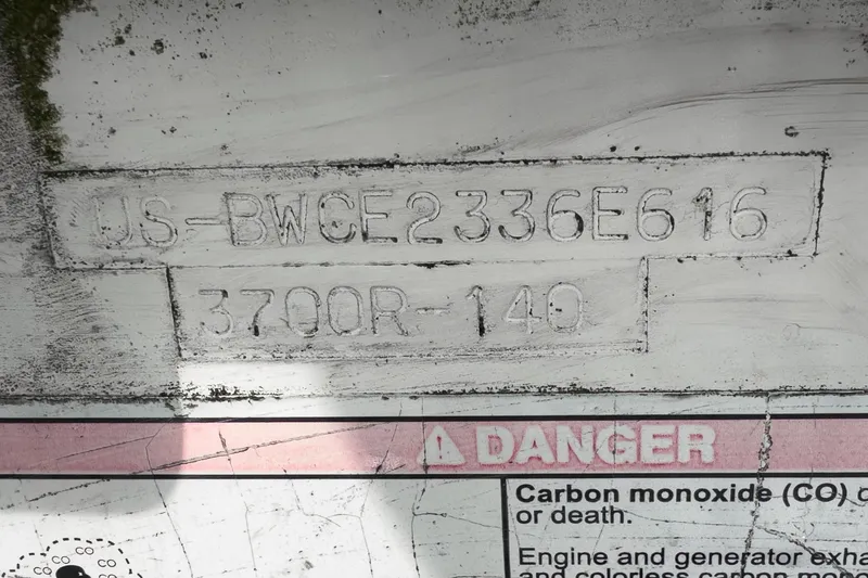 Vaquero Chingon Yacht Photos Pics Hull identification number on 2016 Boston Whaler 370 Outrage boat, showing safety warning.