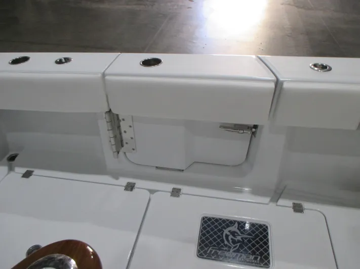  Yacht Photos Pics 2018 Cobia 301 Center Console boat interior with storage compartments and rod holders.