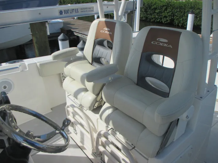  Yacht Photos Pics 2018 Cobia 301 Center Console boat seats with steering wheel, showcasing luxury and comfort.