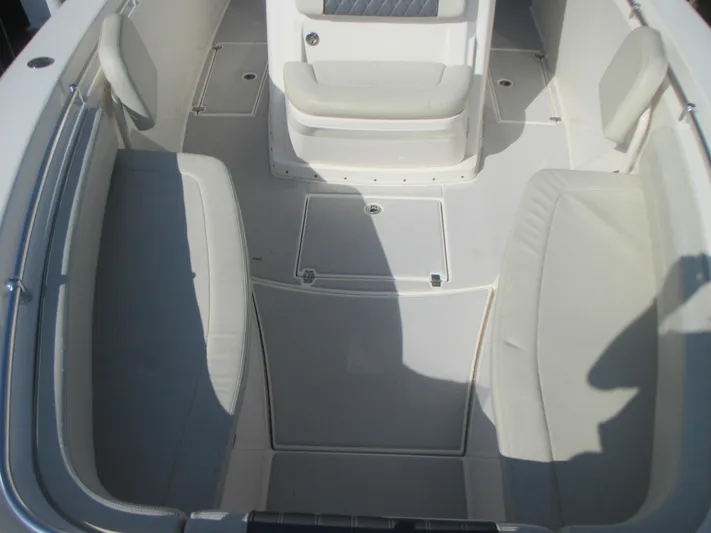  Yacht Photos Pics 2018 Cobia 301 Center Console boat interior with cushioned seating and storage compartments.