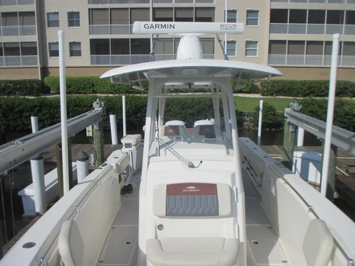  Yacht Photos Pics 2018 Cobia 301 Center Console boat docked, featuring Garmin radar and spacious seating.