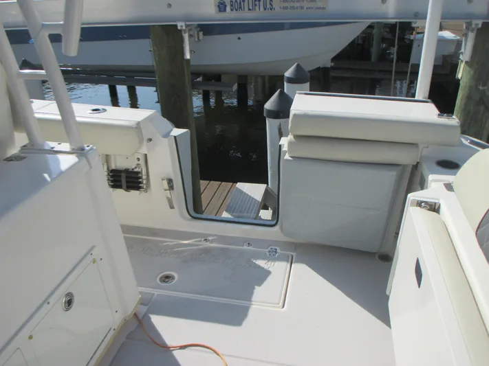  Yacht Photos Pics 2018 Cobia 301 Center Console boat interior with open transom door at dock.