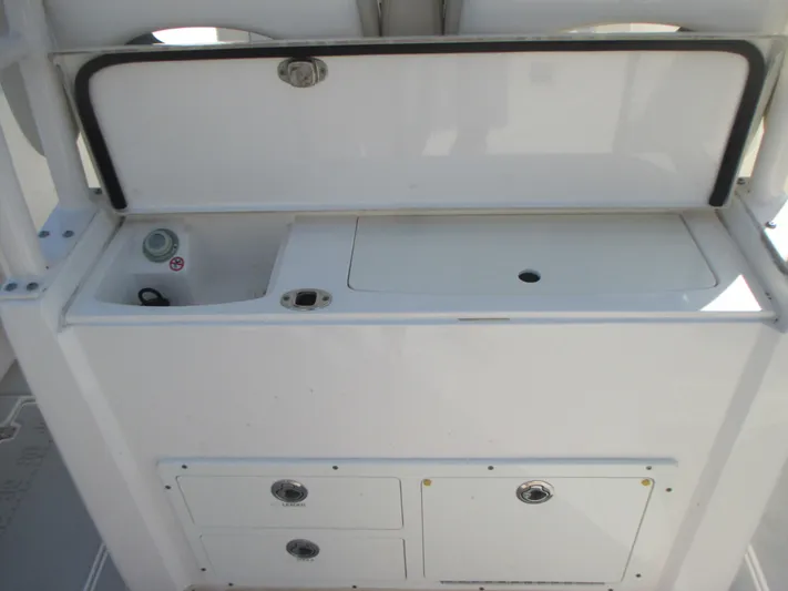  Yacht Photos Pics 2018 Cobia 301 Center Console boat storage and utility area with compartments.