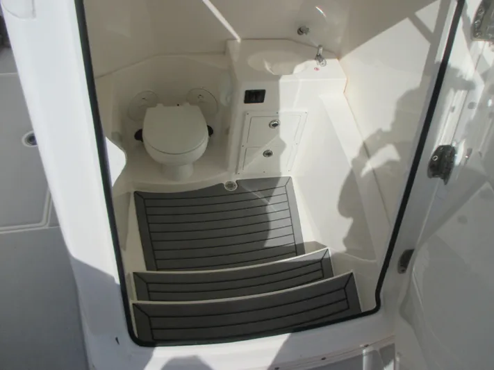  Yacht Photos Pics 2018 Cobia 301 Center Console boat interior with toilet and sink.