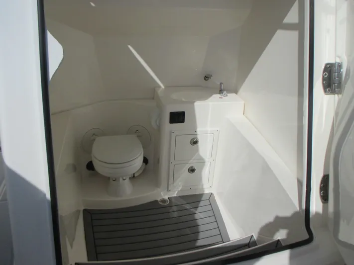  Yacht Photos Pics 2018 Cobia 301 Center Console boat interior with toilet and sink.