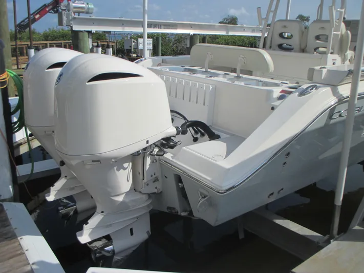  Yacht Photos Pics 2018 Cobia 301 Center Console boat with dual outboard engines docked.