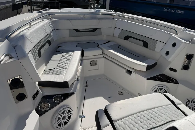  Yacht Photos Pics 2023 Blackfin 302 CC boat interior with cushioned seating and cup holders.