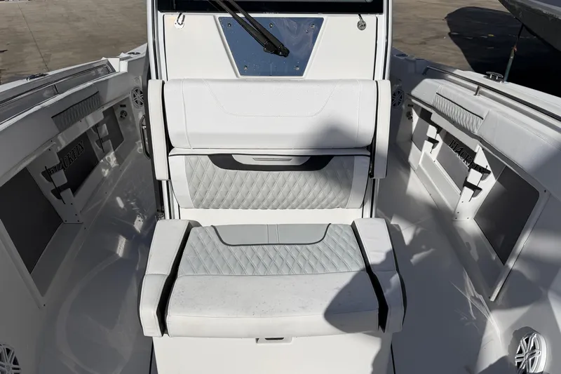  Yacht Photos Pics 2023 Blackfin 302 CC boat interior with cushioned seating and storage compartments.