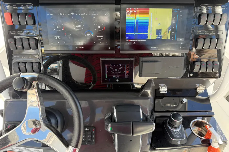  Yacht Photos Pics 2023 Blackfin 302 CC boat dashboard with Garmin navigation displays and controls.