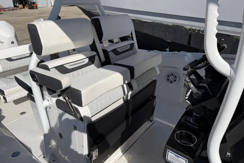  Yacht Photos Pics 2023 Blackfin 302 CC boat interior with dual white cushioned seats and steering console.