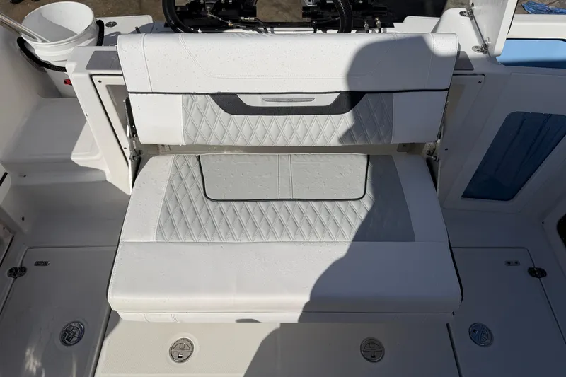  Yacht Photos Pics 2023 Blackfin 302 CC boat seat with diamond-pattern upholstery and storage compartment.