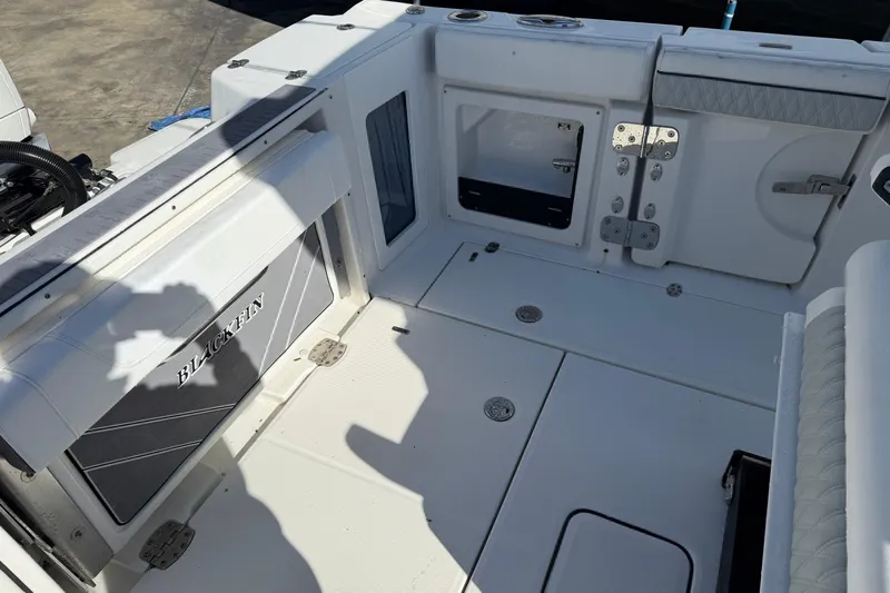 Yacht Photos Pics 2023 Blackfin 302 CC boat interior with storage compartments and seating.