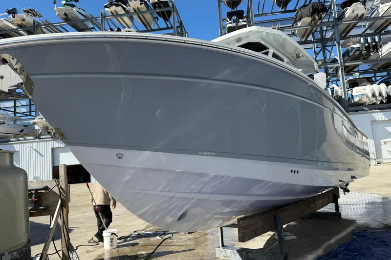 Yacht Photos Pics 2023 Blackfin 302 CC boat in storage, showcasing sleek design and modern features.