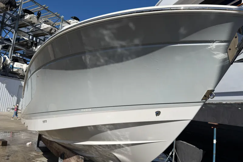  Yacht Photos Pics 2023 Blackfin 302 CC boat in storage, showcasing sleek hull design.
