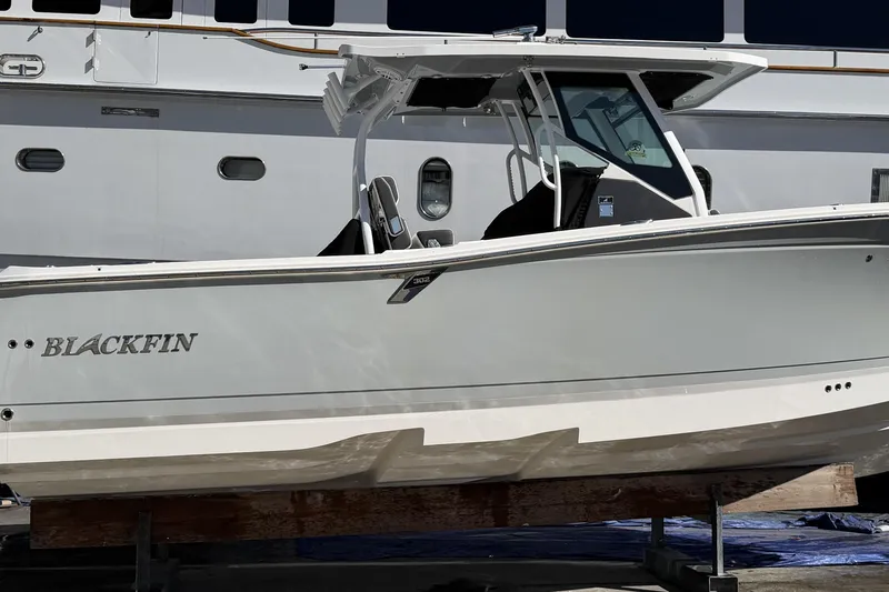  Yacht Photos Pics 2023 Blackfin 302 CC boat displayed on a stand, side view.