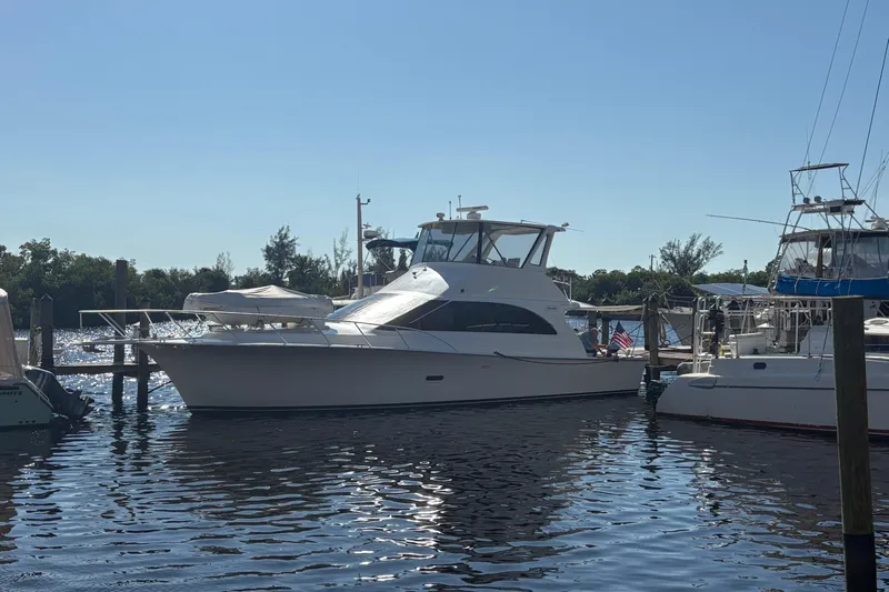 Fender Bender Yacht Photos Pics 1996 Ocean Yachts 48 Super Sport docked at marina under clear blue sky.