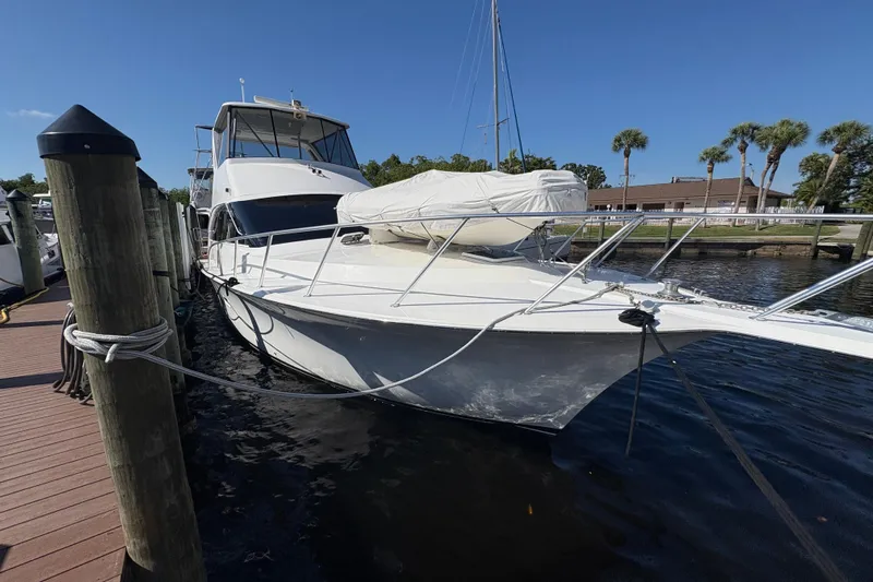 Fender Bender Yacht Photos Pics 1996 Ocean Yachts 48 Super Sport docked at marina under clear blue sky.