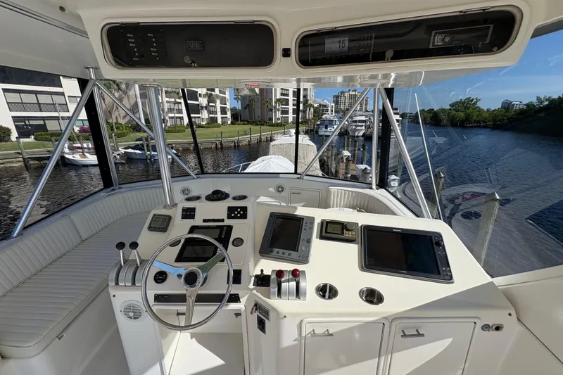 Fender Bender Yacht Photos Pics Cockpit of 1996 Ocean Yachts 48 Super Sport with modern navigation equipment and scenic marina view.