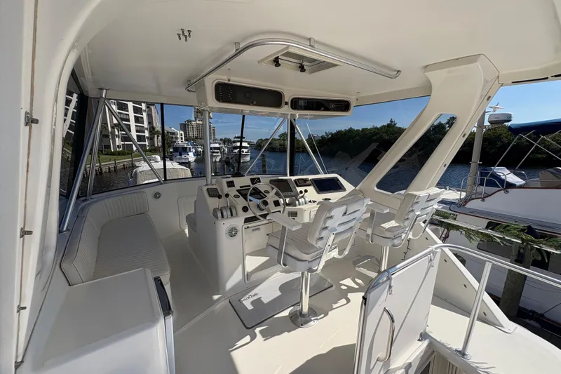 Fender Bender Yacht Photos Pics Cockpit of 1996 Ocean Yachts 48 Super Sport with helm and seating, docked at marina.