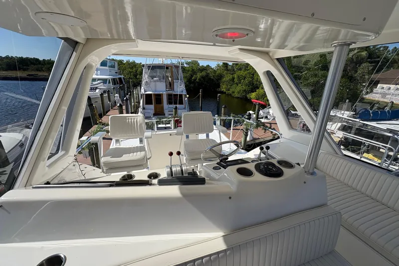 Fender Bender Yacht Photos Pics Interior view of 1996 Ocean Yachts 48 Super Sport, featuring helm and seating area.