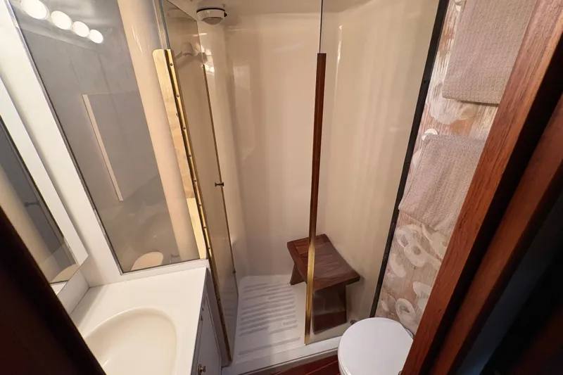 Fender Bender Yacht Photos Pics Bathroom interior of 1996 Ocean Yachts 48 Super Sport with shower and wooden accents.