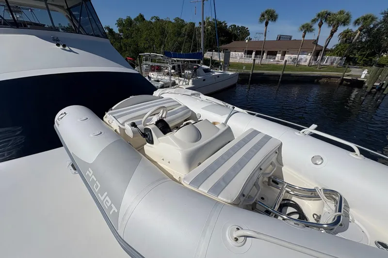Fender Bender Yacht Photos Pics Inflatable boat on 1996 Ocean Yachts 48 Super Sport, docked near palm trees.