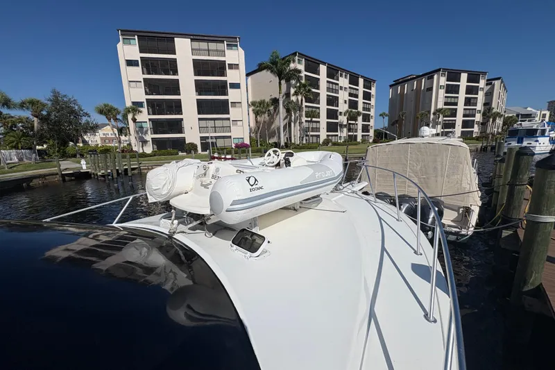 Fender Bender Yacht Photos Pics 1996 Ocean Yachts 48 Super Sport docked near waterfront buildings under clear blue sky.