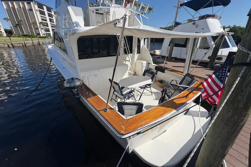 Fender Bender Yacht Photos Pics 1996 Ocean Yachts 48 Super Sport docked, featuring spacious deck and American flag.