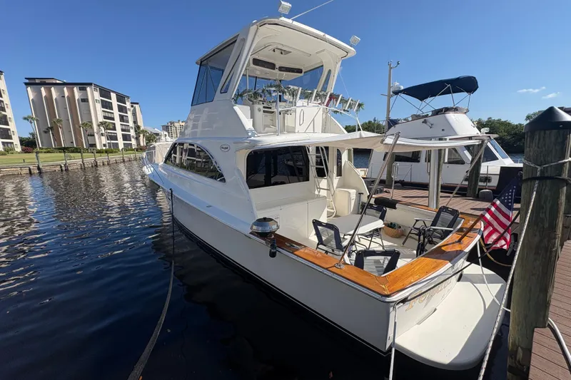 Fender Bender Yacht Photos Pics 1996 Ocean Yachts 48 Super Sport docked, featuring spacious deck and American flag.