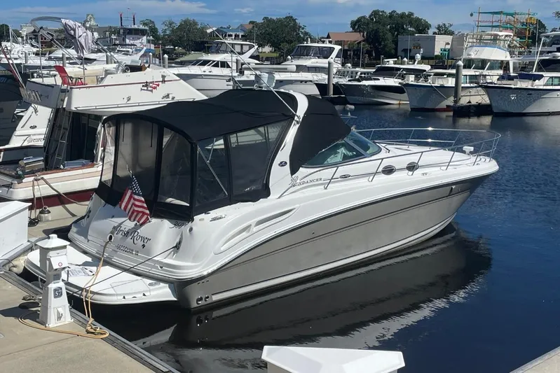 Irish Rover Yacht Photos Pics 2006 Sea Ray 360 Sundancer yacht docked at a marina with American flag.