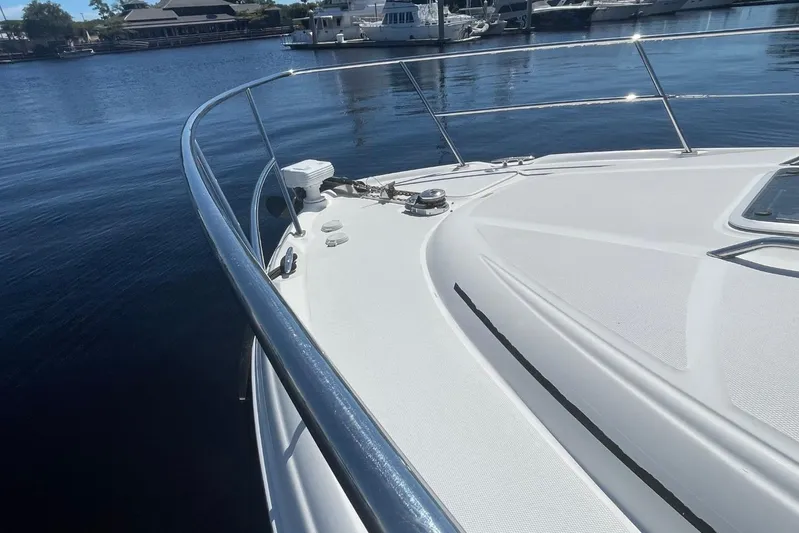 Irish Rover Yacht Photos Pics 2006 Sea Ray 360 Sundancer yacht bow, docked in a marina with calm waters.