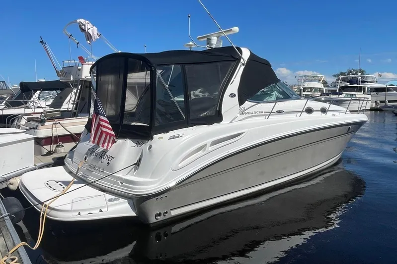 Irish Rover Yacht Photos Pics 2006 Sea Ray 360 Sundancer yacht docked at marina, featuring sleek design and American flag.