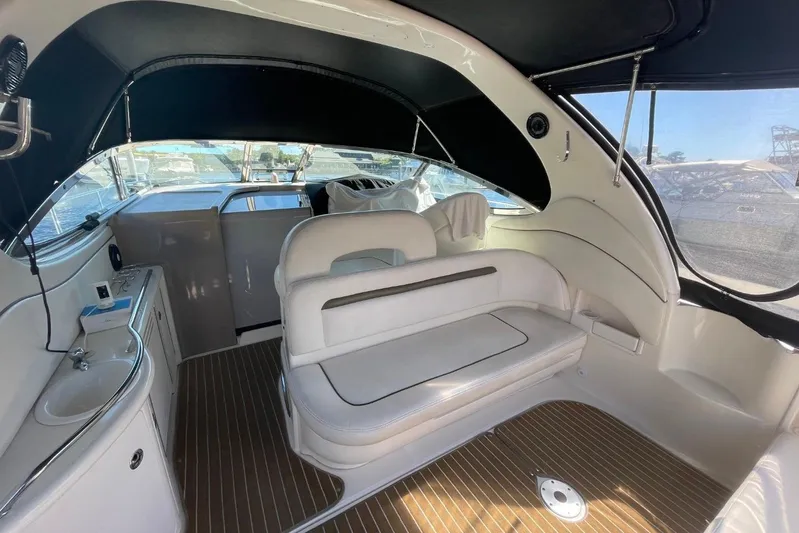 Irish Rover Yacht Photos Pics Interior of 2006 Sea Ray 360 Sundancer yacht with white seating and wood flooring.