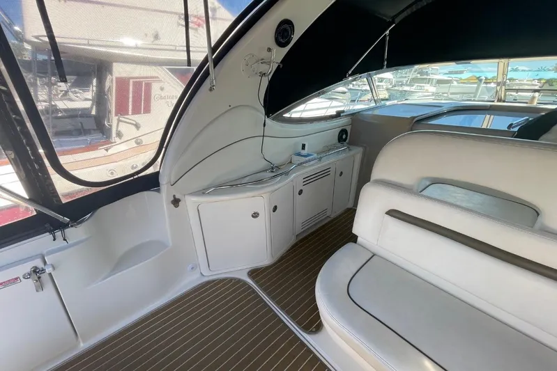 Irish Rover Yacht Photos Pics 2006 Sea Ray 360 Sundancer interior with white seating and wood flooring.