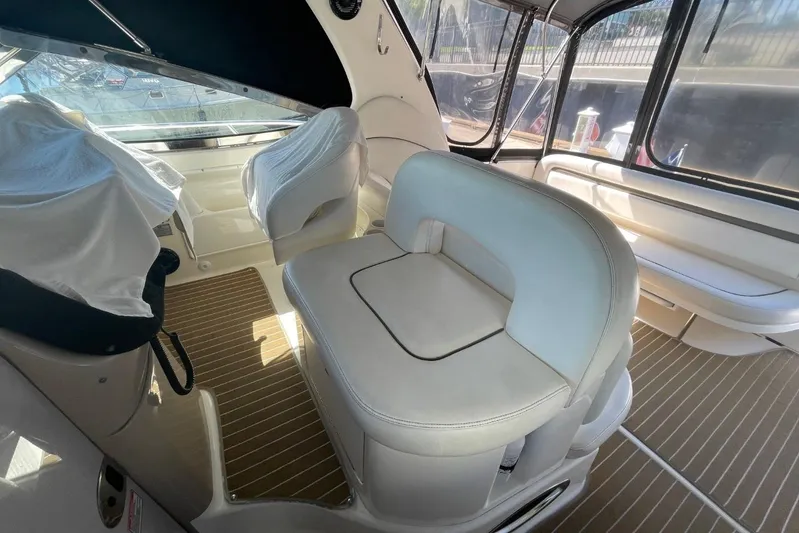 Irish Rover Yacht Photos Pics Interior of 2006 Sea Ray 360 Sundancer yacht with white seating and wood flooring.