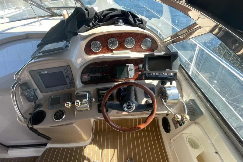 Irish Rover Yacht Photos Pics Helm of 2006 Sea Ray 360 Sundancer with navigation instruments and wooden steering wheel.