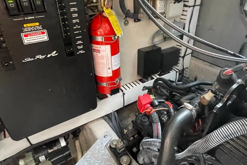 Irish Rover Yacht Photos Pics Engine compartment of a 2006 Sea Ray 360 Sundancer with fire extinguisher and control panel.
