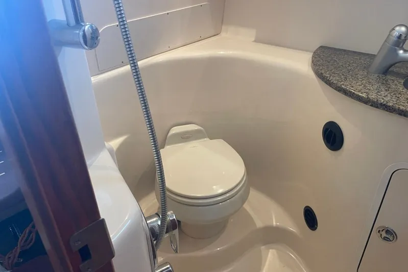 Irish Rover Yacht Photos Pics 2006 Sea Ray 360 Sundancer bathroom with toilet, shower, and granite countertop.