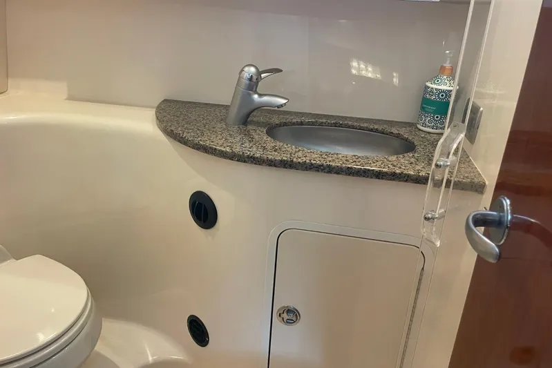 Irish Rover Yacht Photos Pics 2006 Sea Ray 360 Sundancer bathroom with granite countertop and modern fixtures.