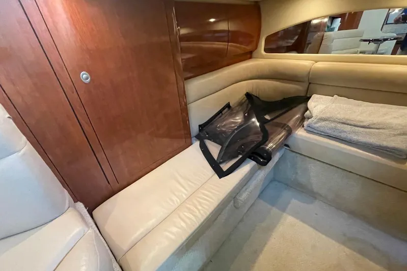 Irish Rover Yacht Photos Pics Interior cabin of 2006 Sea Ray 360 Sundancer with beige seating and wooden paneling.
