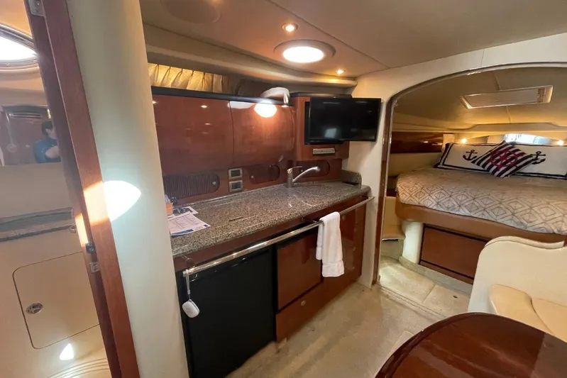 Irish Rover Yacht Photos Pics Interior of 2006 Sea Ray 360 Sundancer yacht with kitchenette and cozy sleeping area.