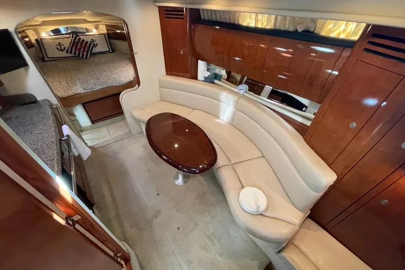 Irish Rover Yacht Photos Pics Luxurious interior of 2006 Sea Ray 360 Sundancer with curved seating and elegant wood finishes.