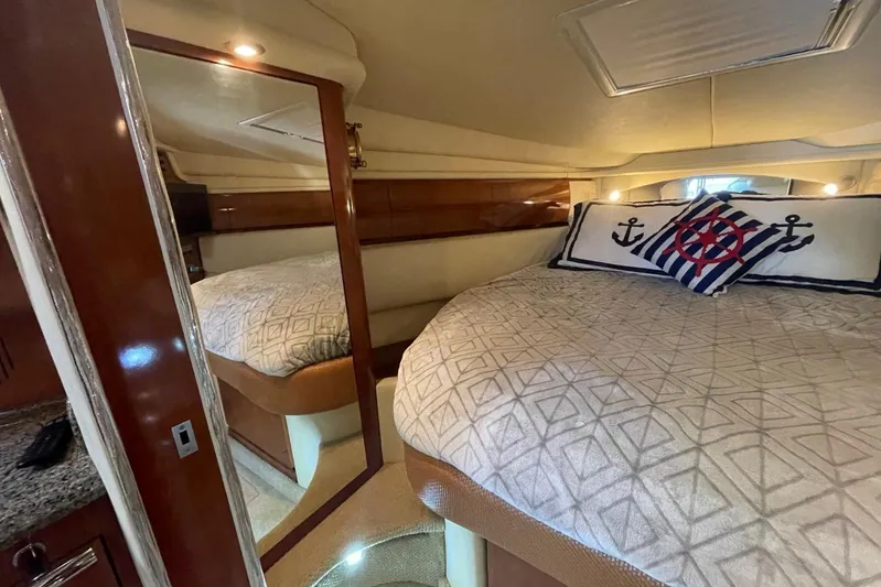 Irish Rover Yacht Photos Pics Luxurious cabin interior of 2006 Sea Ray 360 Sundancer with nautical-themed bedding.