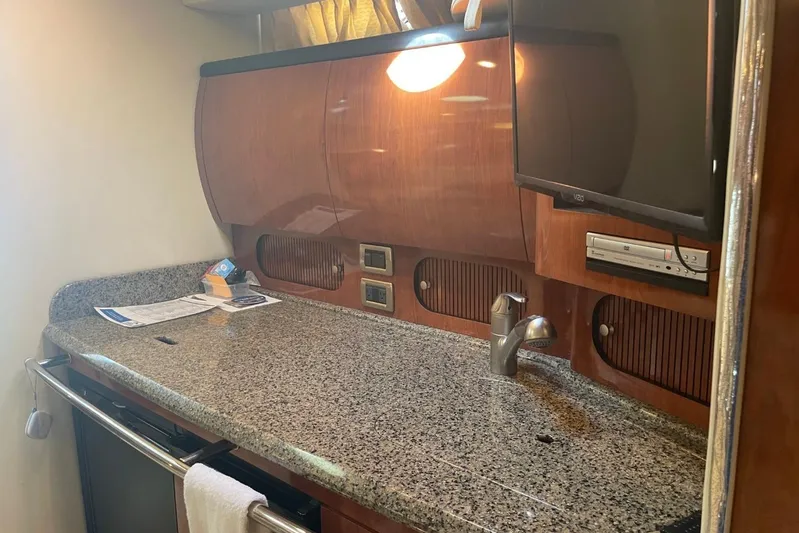 Irish Rover Yacht Photos Pics 2006 Sea Ray 360 Sundancer interior with granite countertop, sink, and mounted TV.