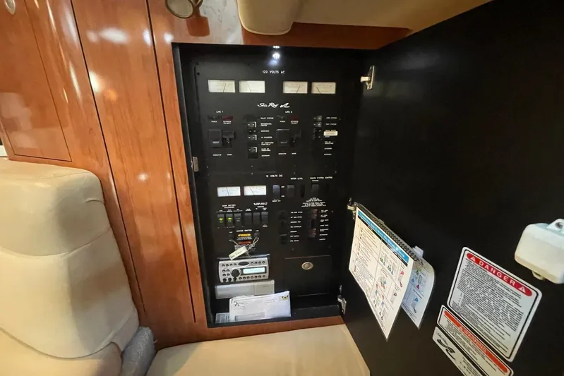 Irish Rover Yacht Photos Pics Electrical panel inside 2006 Sea Ray 360 Sundancer yacht, featuring control switches and safety instructions.